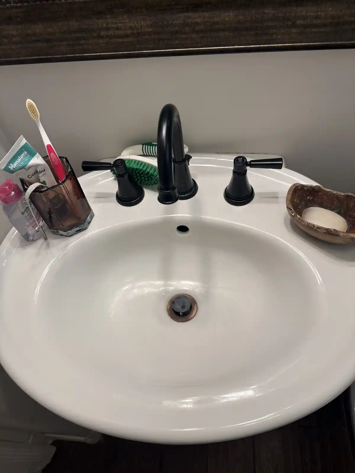The same bathroom sink clean and white, after cleaning