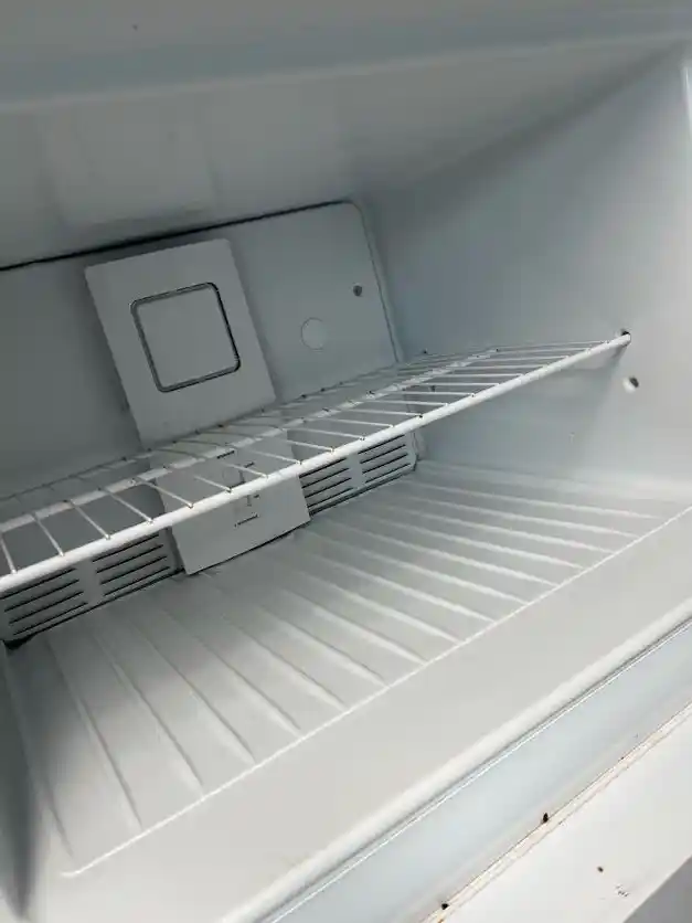 The same refrigerator interior wiped clean, after cleaning