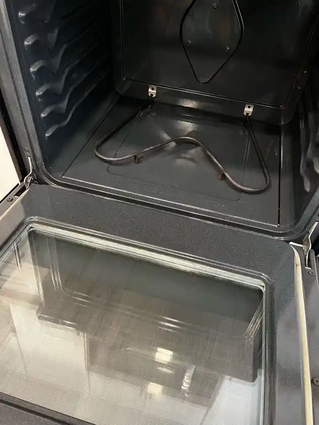 The same oven interior wiped clean, after cleaning